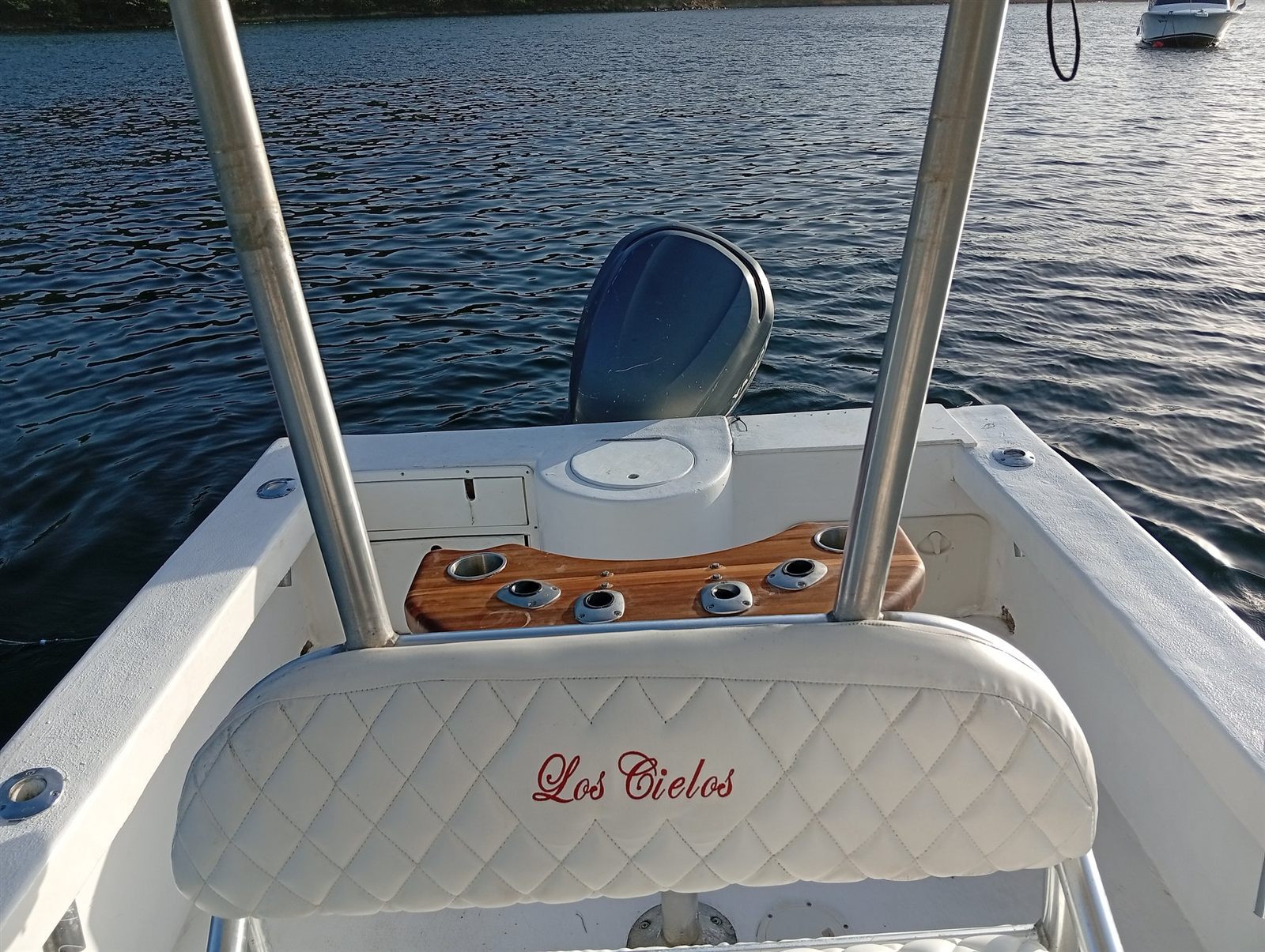 Los Cielos white quilted leaning post with embroidered boat name at the stern