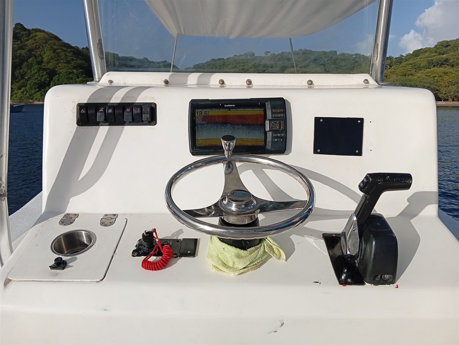 Los Cielos helm with Garmin fish finder and stainless steel steering wheel